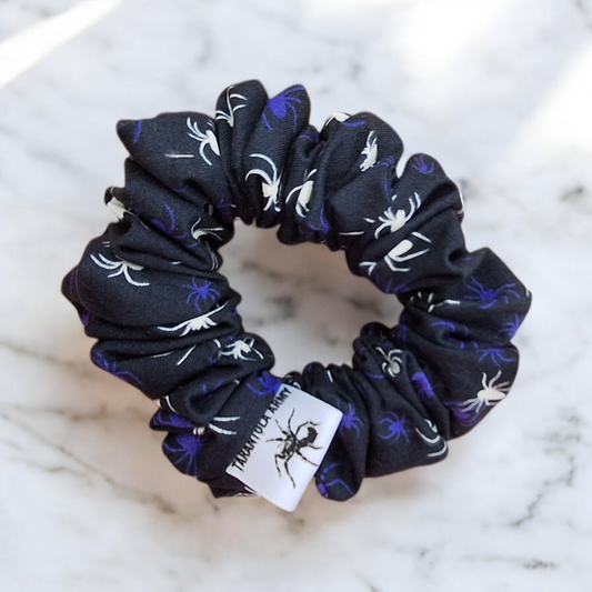 Black scrunchie with white and purple spiders that glow in the dark
