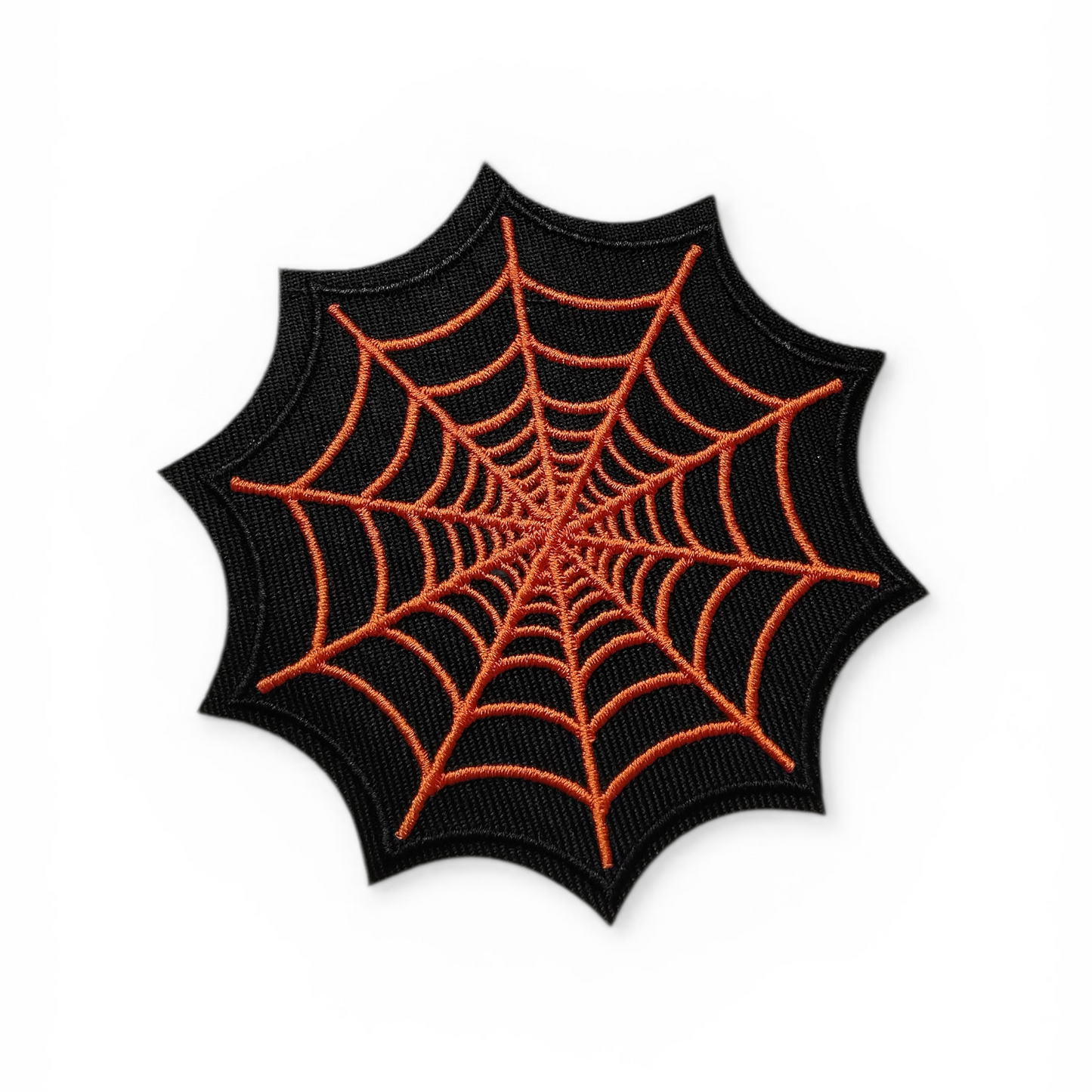 Spider web design patch with orange lines on a black background