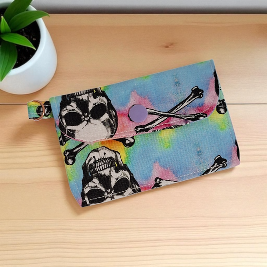 Colorful wallet with skull design on a wooden surface