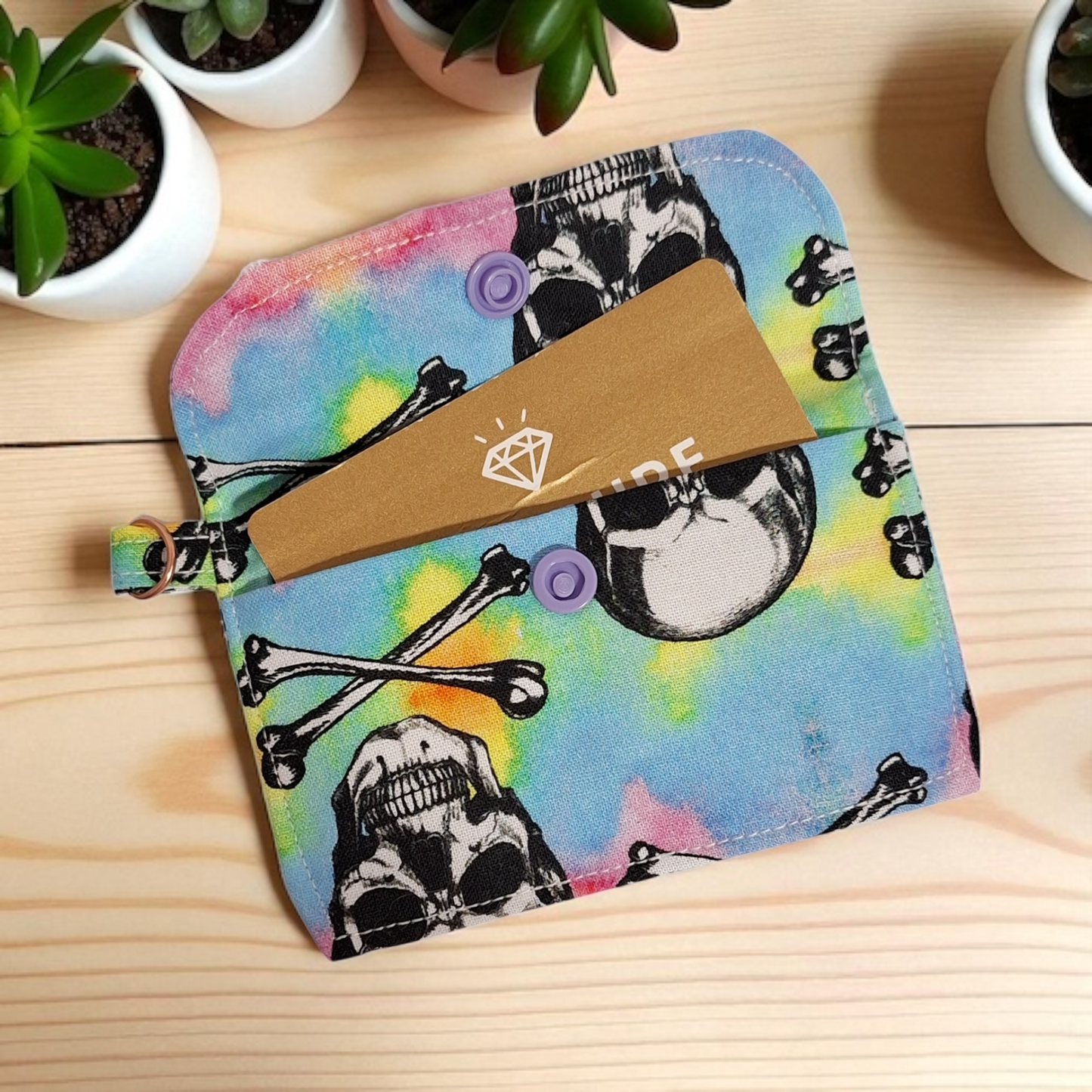 Colorful pouch with skull design on a wooden surface