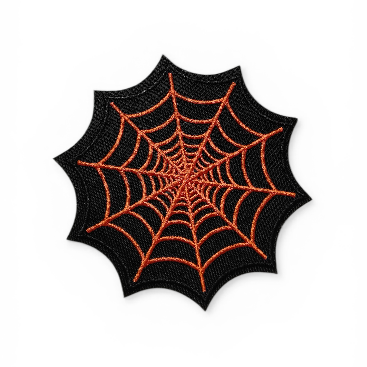 Spider web design patch with orange lines on a black background