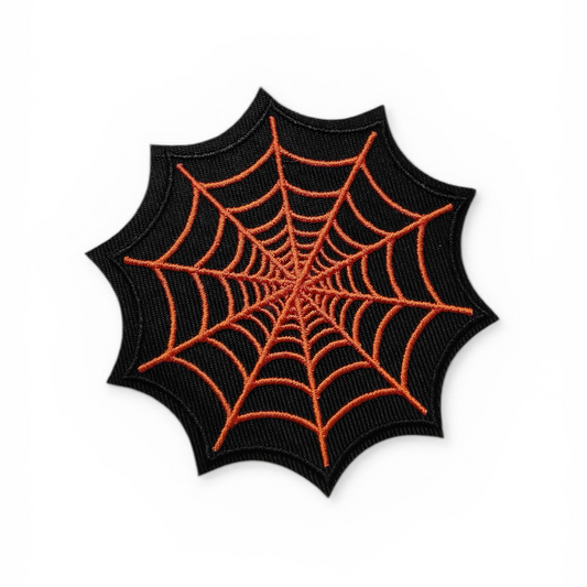 Spider web design patch with orange lines on a black background